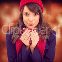 Composite image of festive brunette holding a mug