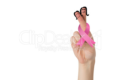 Crossed fingers with breast cancer ribbon