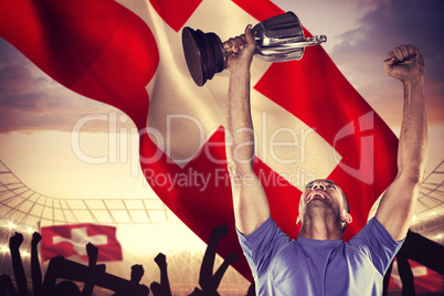 Composite image of happy rugby player holding trophy