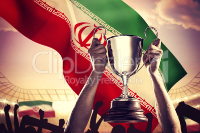 Composite image of successful rugby player holding trophy