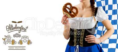 Composite image of pretty oktoberfest girl holding pretzel