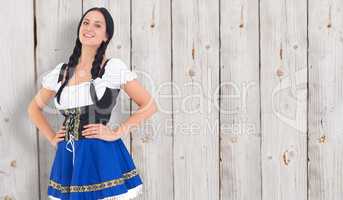 Composite image of pretty oktoberfest girl smiling at camera