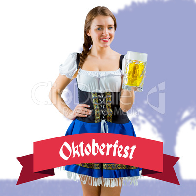 Composite image of pretty oktoberfest girl smiling at camera hol