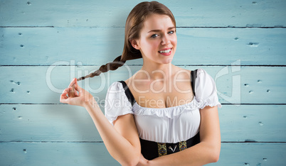 Composite image of pretty oktoberfest girl smiling at camera