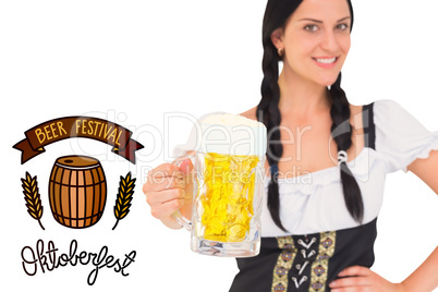 Composite image of pretty oktoberfest girl holding beer tankard