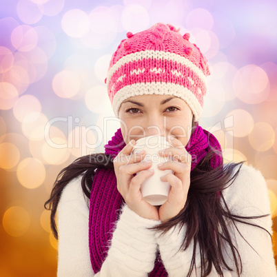 Composite image of winter brunette with coffee