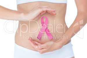 Composite image of woman with hands on belly