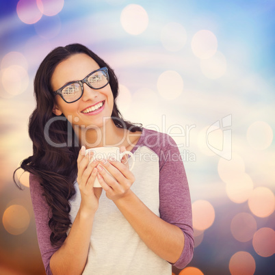 Composite image of brunette with mug