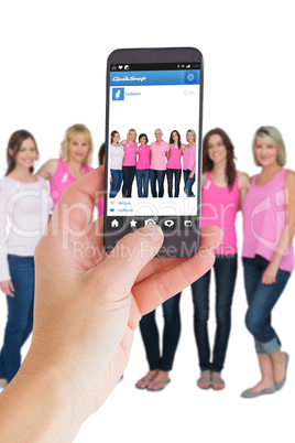 Composite image of female hand holding a smartphone