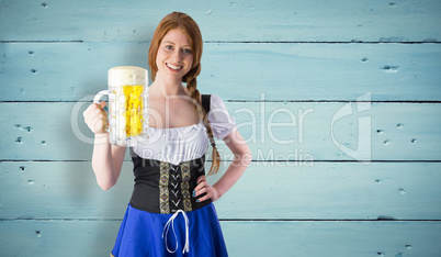 Composite image of oktoberfest girl smiling at camera holding be