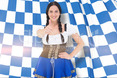 Composite image of pretty oktoberfest girl smiling at camera