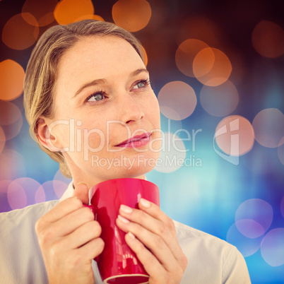 Composite image of businesswoman holding her mug and thinking