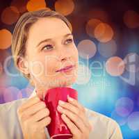 Composite image of businesswoman holding her mug and thinking