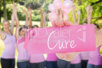 Cure against smiling women in pink for breast cancer awareness