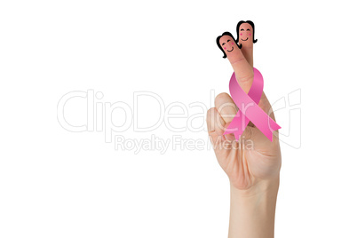 Crossed fingers with breast cancer ribbon