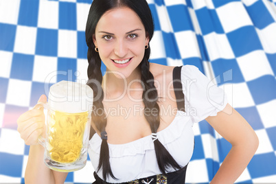 Composite image of pretty oktoberfest girl holding beer tankard