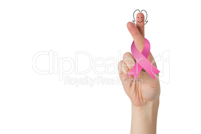 Crossed fingers with breast cancer ribbon