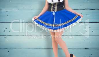 Composite image of oktoberfest girl spreading her skirt