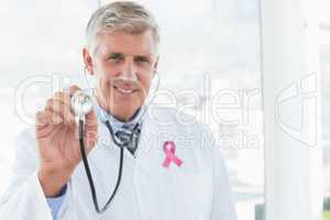 Composite image of happy doctor smiling at camera and showing hi