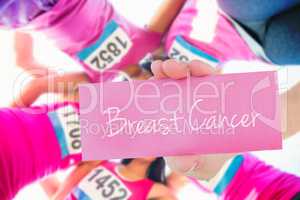 Breast cancer against five smiling runners supporting breast can