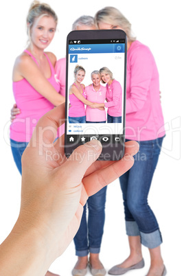 Composite image of female hand holding a smartphone