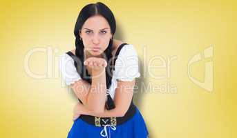 Composite image of pretty oktoberfest girl blowing a kiss