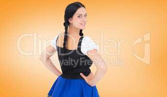 Composite image of pretty oktoberfest girl smiling at camera