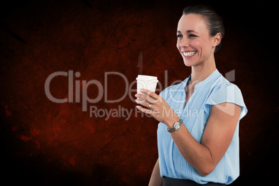 Composite image of smiling businesswoman holding disposable cup