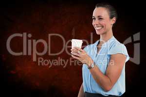 Composite image of smiling businesswoman holding disposable cup