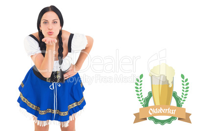 Composite image of pretty oktoberfest girl blowing a kiss