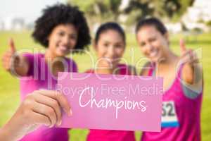 Champions against three smiling runners supporting breast cancer