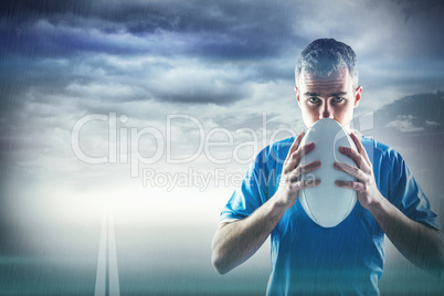 Composite image of rugby player holding a rugby ball Composite image of rugby player holding a rugby ball