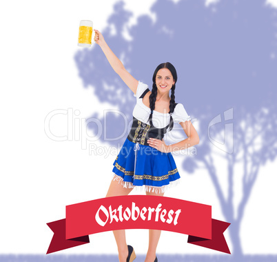 Composite image of pretty oktoberfest girl holding beer tankard