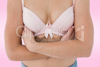 Composite image of woman in bra with breast cancer awareness rib