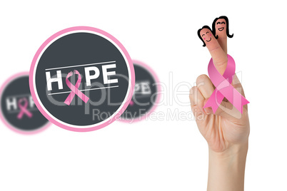 Composite image of crossed fingers with breast cancer ribbon