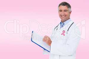 Composite image of happy doctor writing on clipboard