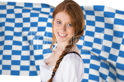 Composite image of oktoberfest girl smiling at camera