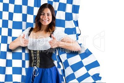 Composite image of pretty oktoberfest girl showing thumbs up