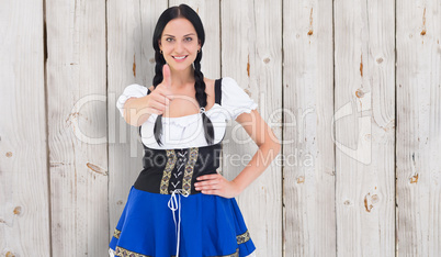 Composite image of pretty oktoberfest girl smiling at camera