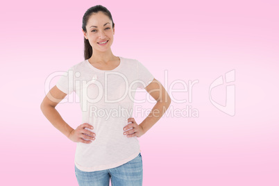 Composite image of smiling women in pink for breast cancer aware