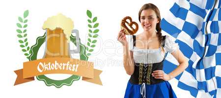 Composite image of pretty oktoberfest girl holding pretzel
