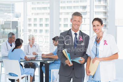 Composite image of portrait of male and female doctors with medi