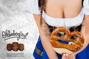 Composite image of oktoberfest girl bending and showing pretzel