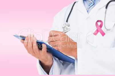 Composite image of doctor writing on clipboard