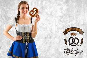 Composite image of pretty oktoberfest girl holding pretzel