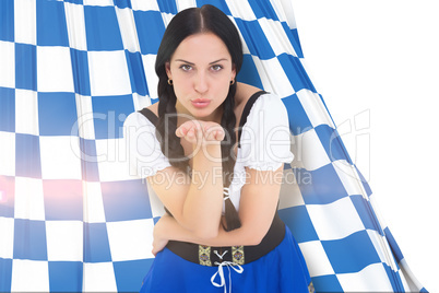 Composite image of pretty oktoberfest girl blowing a kiss