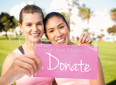 Donate against two smiling women wearing pink for breast cancer