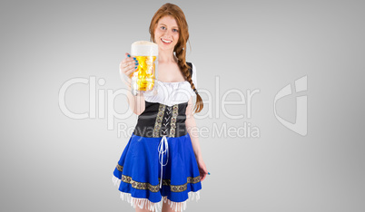 Composite image of oktoberfest girl smiling at camera holding be