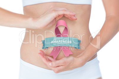 Composite image of woman with hands on belly