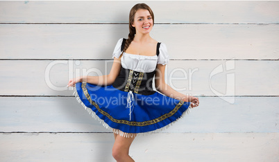 Composite image of oktoberfest girl spreading her skirt